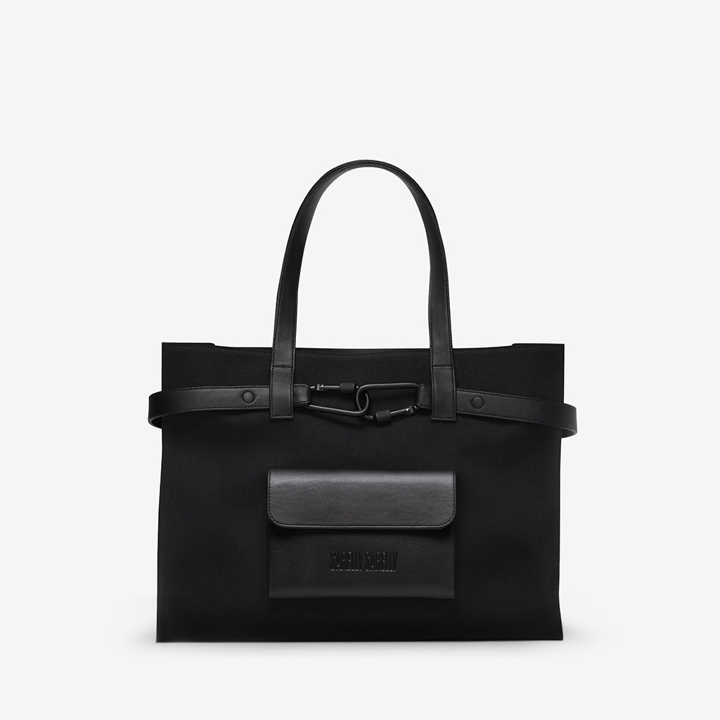 A black tote bag with leather handles and a front pocket.